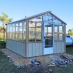 white wooden greenhouse sunview builder